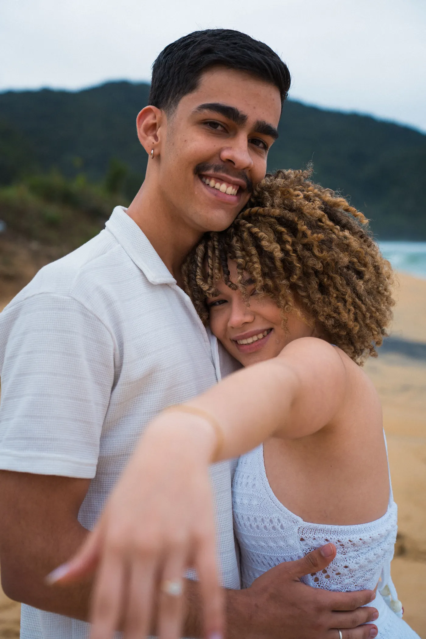 O casal abraçado mostrando a aliança pra câmera — foto autoral de Renan Life, Ubatuba